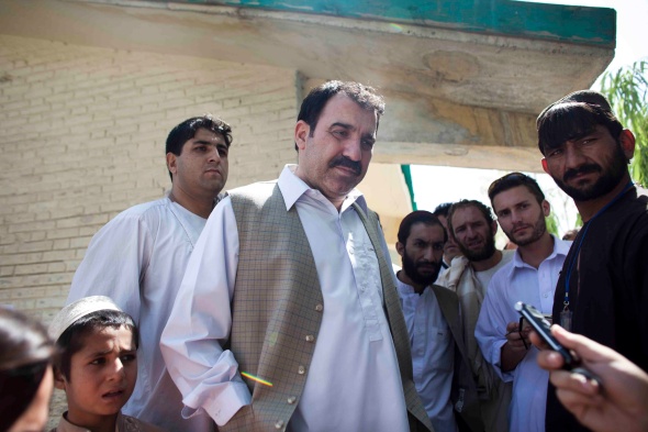 Ahmed Wali Karzai makes a statement immediately after casting his vote at a polling booth in Kandahar City on August 20, 2009. Julius Cavendish second from right (Jonathan Saruk)